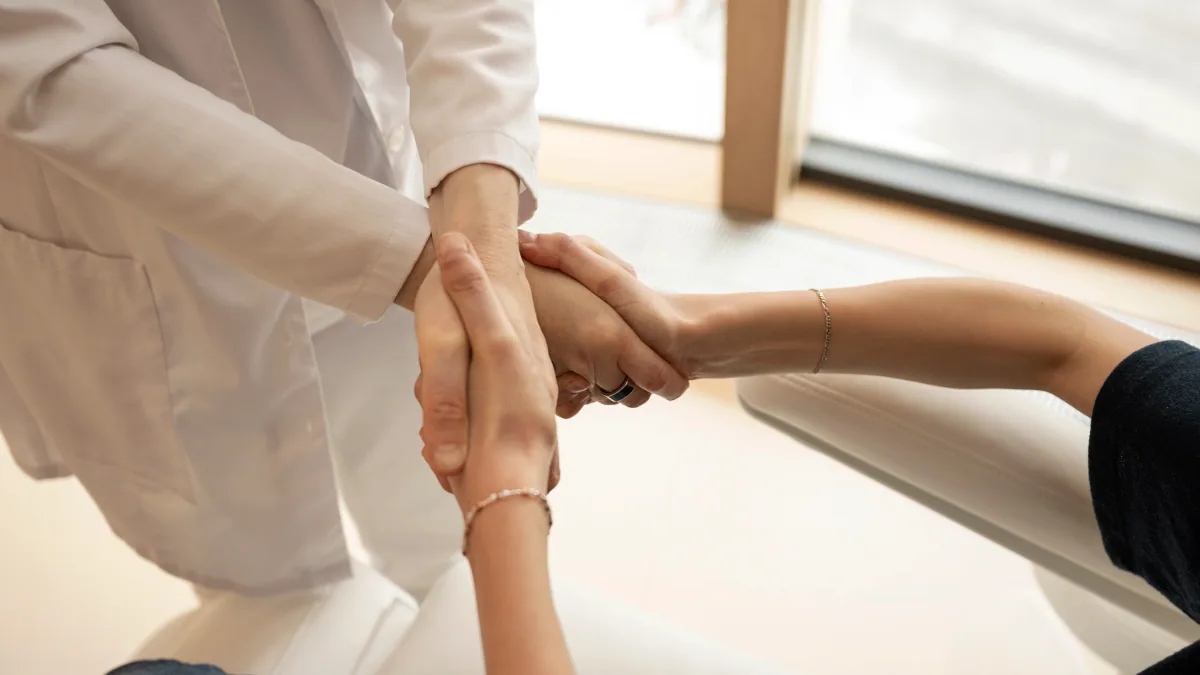 Sand Clinic clinician examining a patient's wrist