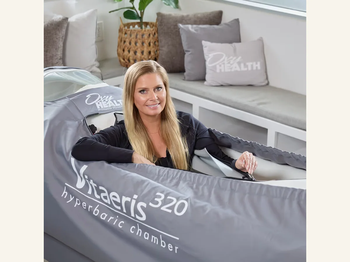 OxyHealth Vitaeris 320 chamber shown open with a person inside